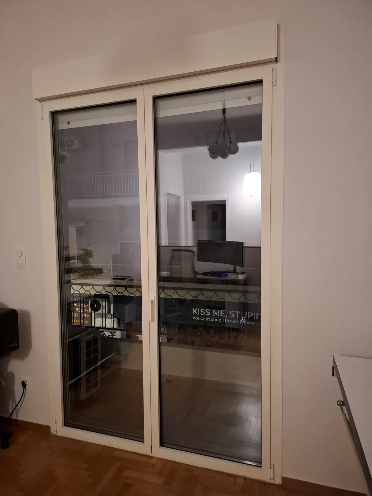 A two-leaf opening in white aluminium in the office space, looking out to the street